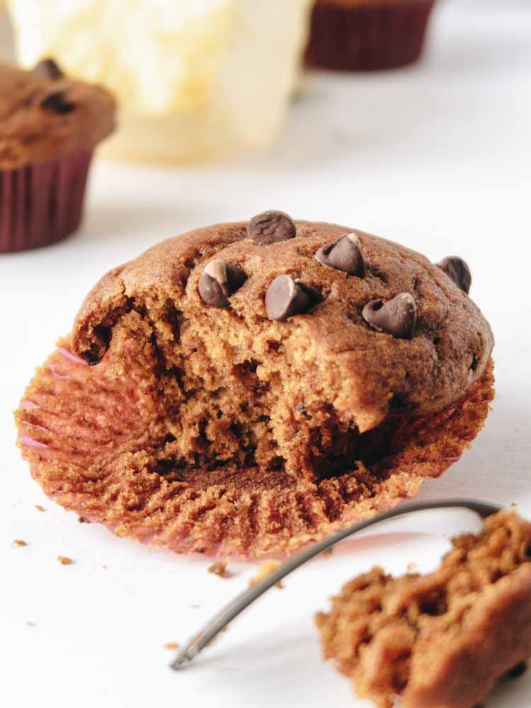 A Vegan Pumpkin Muffins with Chocolate Chips with a bite taken
